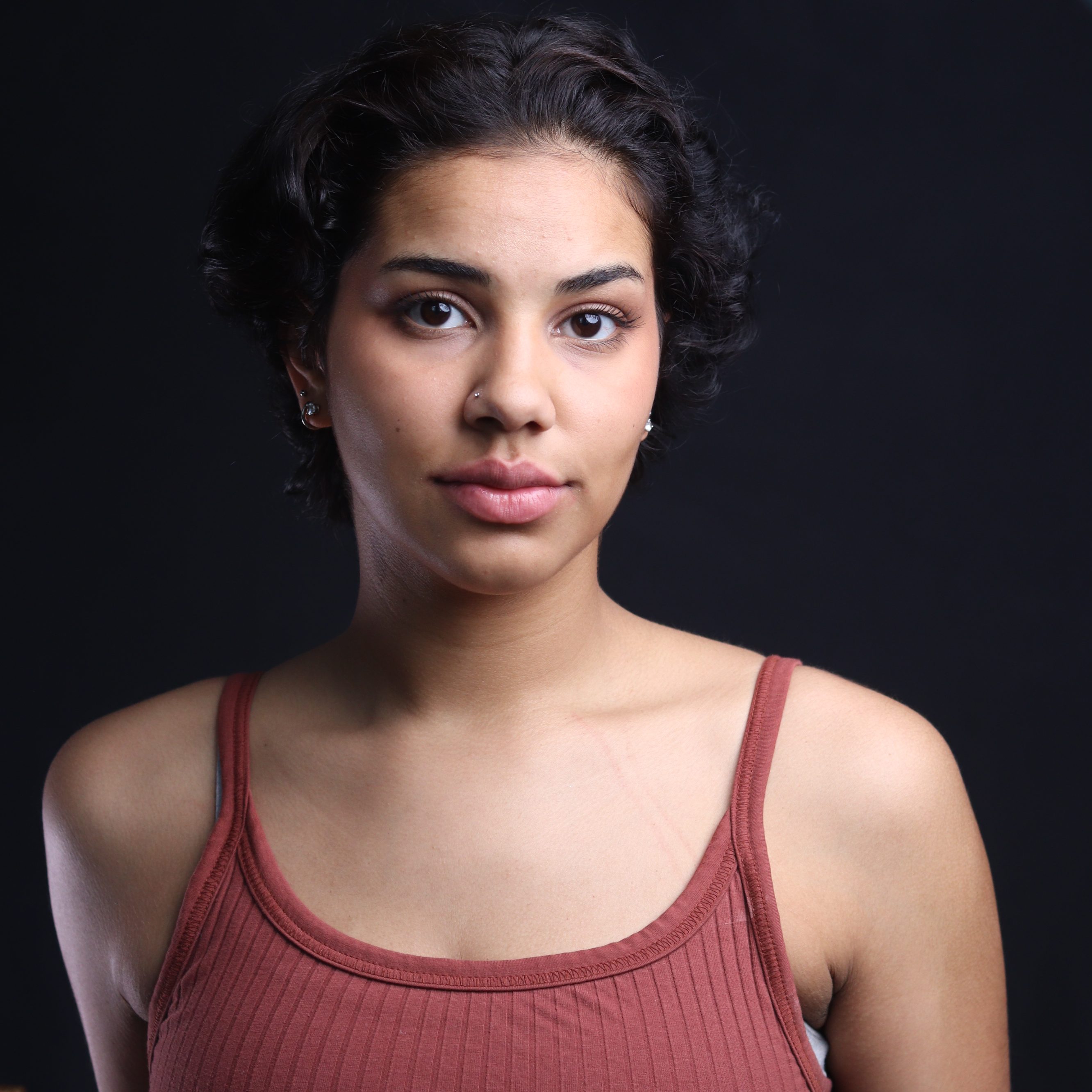 A professional headshot of Maez Gordon with a slight smile.